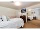 Cozy bedroom features neutral carpet, mounted TV, and closet with mirrored sliding doors at 6666 S Pennsylvania St, Centennial, CO 80121