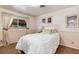 Cozy bedroom with white comforter, matching curtains and artwork, and a bright window at 6666 S Pennsylvania St, Centennial, CO 80121