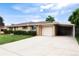 Exterior view with an attached garage and a porte-cochere at 6666 S Pennsylvania St, Centennial, CO 80121