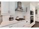 Kitchen showcasing a stainless steel range hood, oven, and white cabinets with granite countertops at 6666 S Pennsylvania St, Centennial, CO 80121