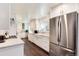 Bright kitchen featuring white cabinets, stainless steel appliances, wood floors, and granite countertops at 6666 S Pennsylvania St, Centennial, CO 80121