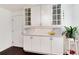 Kitchen featuring bright white cabinetry, stainless steel hardware and a view to the front yard at 6666 S Pennsylvania St, Centennial, CO 80121