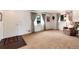 Inviting living room with large windows, neutral carpet, and an open layout at 6666 S Pennsylvania St, Centennial, CO 80121