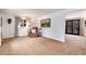 Spacious living room with neutral carpet, large window, and adjacent seating area at 6666 S Pennsylvania St, Centennial, CO 80121