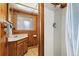 Bathroom with a white shower, wood wall paneling, and vanity at 77 Krestview Ln, Golden, CO 80401