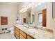 This bathroom features double sinks, granite countertops, and framed mirror, with bathtub at 77 Krestview Ln, Golden, CO 80401