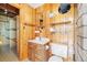 Bathroom features wood cabinets and walls, linoleum floors, toilet, and sink at 77 Krestview Ln, Golden, CO 80401