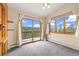 This bedroom features carpeted floors, natural light from windows and sliding glass door at 77 Krestview Ln, Golden, CO 80401