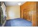 A classic bedroom with wood paneling and closet doors offers a cozy, vintage aesthetic at 77 Krestview Ln, Golden, CO 80401