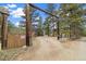 Long driveway leading to the house past a wood security gate and wooded areas at 77 Krestview Ln, Golden, CO 80401