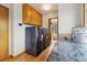 A modern laundry room boasts front load washer and dryer, wood floors, and granite counters at 77 Krestview Ln, Golden, CO 80401