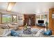 Warm living room with hardwood floors, brick fireplace, bay window, and natural light at 77 Krestview Ln, Golden, CO 80401