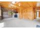 Cozy living room with wood paneled walls, wood stove, brick accent and natural light at 77 Krestview Ln, Golden, CO 80401