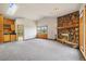 An open living room boasts a stone fireplace, carpet, and beautiful mountain views from multiple windows at 77 Krestview Ln, Golden, CO 80401