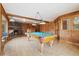 Expansive living room boasts a pool table, stone fireplace, and wooden accents at 77 Krestview Ln, Golden, CO 80401