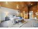 The main bedroom boasts wood paneled walls, a seating area, and access to an ensuite bathroom at 77 Krestview Ln, Golden, CO 80401
