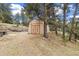This property features a barn-style outbuilding with wood doors, surrounded by mature trees at 77 Krestview Ln, Golden, CO 80401