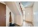 The entryway features wood-look tile flooring, white walls, coat rack, and stairwell access at 2695 S Ames Way # 1, Lakewood, CO 80227
