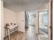 The entryway features wood-look tile flooring, a table, and access to other rooms at 2695 S Ames Way # 1, Lakewood, CO 80227