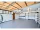 Spacious two car garage offers ample storage with cabinets and workspace with pegboard at 2695 S Ames Way # 1, Lakewood, CO 80227