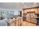 The kitchen features hardwood floors, stainless steel appliances, and a granite countertop island at 2695 S Ames Way # 1, Lakewood, CO 80227