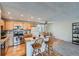 The kitchen features stainless steel appliances, hardwood floors, an island, and updated lighting at 2695 S Ames Way # 1, Lakewood, CO 80227