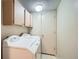 Laundry room features a washer, dryer, cabinets for storage and a utility door at 2695 S Ames Way # 1, Lakewood, CO 80227