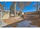 Landscaped backyard with a small shed, a large tree, and terraced retaining walls at 3348 S Corona St, Englewood, CO 80113