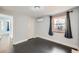 Bright bedroom with hardwood floors, a classic light fixture, and a neutral color palette at 3348 S Corona St, Englewood, CO 80113