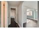 Hallway featuring dark wood floors, neutral paint, and an archway leading to another room at 3348 S Corona St, Englewood, CO 80113