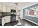 Eat-in kitchen featuring modern appliances and a bay window at 3348 S Corona St, Englewood, CO 80113