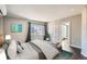 Cozy main bedroom featuring cool tones, dark wood floors, ample natural light, and ensuite bathroom at 3348 S Corona St, Englewood, CO 80113