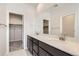 Double vanity bathroom with dark brown cabinets and quartz countertops at 14083 Deertrack Ln, Parker, CO 80134