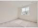 Well-lit bedroom featuring carpeted floors and a window at 14083 Deertrack Ln, Parker, CO 80134