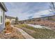 Landscaped backyard with stone pathway, retaining wall and lawn at 12432 Meadowlark Ln, Broomfield, CO 80021