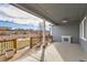 Covered patio with wood deck, fire pit, and fenced backyard at 12432 Meadowlark Ln, Broomfield, CO 80021