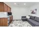 Finished basement recreation room with wet bar, comfortable seating area, and large TV at 12432 Meadowlark Ln, Broomfield, CO 80021