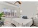 Bright bedroom with white metal bed frame and light wood floors at 12432 Meadowlark Ln, Broomfield, CO 80021