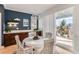 Kitchen dining area with white table and chairs, offering backyard access at 12432 Meadowlark Ln, Broomfield, CO 80021