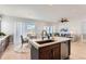 Eat-in kitchen with island, stainless steel appliances and Gathering room view at 12432 Meadowlark Ln, Broomfield, CO 80021