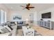 Cozy living room featuring a sectional sofa, a coffee table, and built-in shelving at 12432 Meadowlark Ln, Broomfield, CO 80021