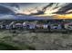 A picturesque view of a neat row of homes each boasting inviting decks, set against a mountain backdrop at 15788 Valentia St, Thornton, CO 80602