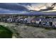 Neighborhood showing beautiful houses each with a backyard deck, lined up neatly at sundown at 15788 Valentia St, Thornton, CO 80602