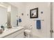 Well-lit bathroom featuring a modern vanity with sink, toilet, framed art, and neutral wall décor at 15788 Valentia St, Thornton, CO 80602