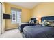Comfortable bedroom with two twin beds, a window, a mounted TV, and neutral carpet at 15788 Valentia St, Thornton, CO 80602