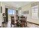 Dining room with hardwood floors, round table, and large windows for abundant light at 15788 Valentia St, Thornton, CO 80602