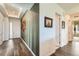 Welcoming foyer with stylish wallpaper, hardwood flooring, and ample natural light at 15788 Valentia St, Thornton, CO 80602