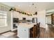 Modern kitchen featuring white cabinets, quartz countertops, and stainless steel appliances at 15788 Valentia St, Thornton, CO 80602