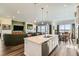 Bright, open kitchen flows into living room with large island and stainless steel appliances at 15788 Valentia St, Thornton, CO 80602