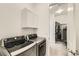 Laundry room featuring modern washer and dryer and a peek into the walk-in closet at 15788 Valentia St, Thornton, CO 80602